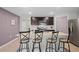 Contemporary kitchen with stainless steel appliances, dark cabinets, and an island with bar stools at 8508 Bay Dr, Spring Hill, FL 34606