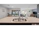 Stainless steel sink in a spacious kitchen with views to an outdoor dining area at 8508 Bay Dr, Spring Hill, FL 34606