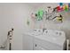 Functional laundry room features a washer, dryer, and storage shelves at 8508 Bay Dr, Spring Hill, FL 34606