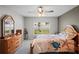 Bedroom featuring a ceiling fan, a dresser, and a window with a view of the backyard at 8508 Bay Dr, Spring Hill, FL 34606