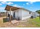 Exterior view of home featuring a back patio with pergola, access doors, and partial fencing at 8708 Albion Ct, Tampa, FL 33634