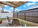 Cozy backyard patio featuring an open-air pergola, wooden fence, and comfortable seating area at 8708 Albion Ct, Tampa, FL 33634