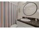 Bathroom featuring a vanity with white cabinets, granite countertop and modern sink at 8708 Albion Ct, Tampa, FL 33634