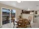 Bright dining area with a round wooden table, chairs, and sliding glass doors providing natural light and outdoor access at 8708 Albion Ct, Tampa, FL 33634