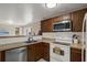 Traditional kitchen with wooden cabinets, tile backsplash, and stainless steel appliances, offering a functional cooking space at 8708 Albion Ct, Tampa, FL 33634