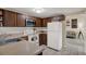 Bright kitchen features wood cabinetry, white appliances, and lots of countertop space, connecting to the dining area at 8708 Albion Ct, Tampa, FL 33634