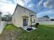 A spacious backyard features a basketball hoop, sliding glass door, and partial privacy fence at 9126 Lantern Oak Way, Land O Lakes, FL 34638