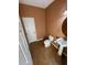 A well-maintained bathroom featuring a pedestal sink and matching toilet at 9126 Lantern Oak Way, Land O Lakes, FL 34638