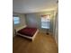 Bedroom featuring a clean design, tiled floor, and natural light from two windows at 9126 Lantern Oak Way, Land O Lakes, FL 34638