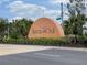 A large Tierra del Sol community sign landscaped with palm trees and flowering shrubs at 9126 Lantern Oak Way, Land O Lakes, FL 34638