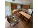 Bright eat-in kitchen featuring stainless steel appliances, wood cabinetry, an island with seating, and adjacent breakfast nook at 9126 Lantern Oak Way, Land O Lakes, FL 34638