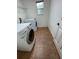 Functional laundry room with side-by-side washer and dryer, maximizing space efficiency at 9126 Lantern Oak Way, Land O Lakes, FL 34638