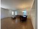 Bright living room featuring neutral colored walls, tile flooring, natural light, and views into other living spaces at 9126 Lantern Oak Way, Land O Lakes, FL 34638