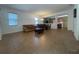 Spacious living room featuring tile flooring, neutral walls, living room furniture, and views into other living spaces at 9126 Lantern Oak Way, Land O Lakes, FL 34638