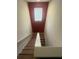 A stairway leads to another floor, illuminated by a window at the top at 9126 Lantern Oak Way, Land O Lakes, FL 34638