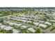 Overview of a neighborhood with houses, a pond, and lush green golf course at 9226 41St N St, Pinellas Park, FL 33782