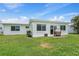Spacious backyard with a lush green lawn, patio, and bright exterior at 9226 41St N St, Pinellas Park, FL 33782