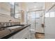 Elegant bathroom features a glass-enclosed shower, sleek vanity, and neutral tile flooring at 9226 41St N St, Pinellas Park, FL 33782