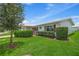 Well-maintained house with red shutters, lush green lawn, and mature tree at 9226 41St N St, Pinellas Park, FL 33782