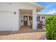 Inviting front porch featuring brick pavers, rocking chair, fire pit, and well manicured green hedges at 9226 41St N St, Pinellas Park, FL 33782