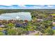 Aerial view of property near lake with fountain, showcasing surrounding landscape and community amenities at 9416 Lake Chase Island Way # 9416, Tampa, FL 33626