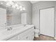 Bathroom with double sinks, large mirror, and closet space at 9416 Lake Chase Island Way # 9416, Tampa, FL 33626