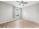 Bedroom with tile floors, ceiling fan, and view to backyard at 9416 Lake Chase Island Way # 9416, Tampa, FL 33626