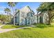 Well-manicured exterior of home with lush green lawn, sidewalk, and mature trees providing shade at 9416 Lake Chase Island Way # 9416, Tampa, FL 33626