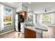 Kitchen with stainless steel appliances, breakfast bar, and a window overlooking the landscape at 9416 Lake Chase Island Way # 9416, Tampa, FL 33626