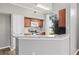 Well-lit kitchen featuring granite countertops, stainless steel appliances, and wood cabinets at 9416 Lake Chase Island Way # 9416, Tampa, FL 33626