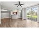 Open-concept living room with wood flooring, overlooking kitchen, and large sliding glass doors at 9416 Lake Chase Island Way # 9416, Tampa, FL 33626