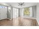 Bright living room with wood floors, white walls, and large windows providing natural light at 9416 Lake Chase Island Way # 9416, Tampa, FL 33626