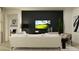Chic living room with modern furniture, a dark accent wall, and stylish decor at 9486 Gladsome Dr, Land O Lakes, FL 34637