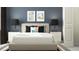 Serene bedroom with neutral tones, decorative art, and bedside tables with stylish lamps at 10808 Keato Beach Ct, Tampa, FL 33647