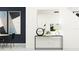 Modern entryway with a sleek console table, decorative mirror, and minimalist artwork creating an inviting space at 10808 Keato Beach Ct, Tampa, FL 33647