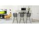 Eat-in kitchen boasts white cabinets, modern appliances, and a breakfast bar with seating at 10808 Keato Beach Ct, Tampa, FL 33647