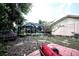 Spacious backyard featuring a screened-in pool enclosure, patio area, and shade trees at 11411 N 19Th St, Tampa, FL 33612