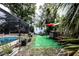 Inviting backyard with a screened-in pool, small shed, dining set and bar, perfect for entertaining guests at 11411 N 19Th St, Tampa, FL 33612