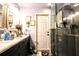 Bathroom features a double sink vanity, a neutral color palette, and a glass-enclosed shower at 11411 N 19Th St, Tampa, FL 33612