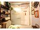 Bathroom featuring a shower with sliding glass doors, storage shelves, and updated fixtures at 11411 N 19Th St, Tampa, FL 33612