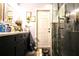 Bathroom featuring sleek vanity with framed mirror and a glass enclosed shower at 11411 N 19Th St, Tampa, FL 33612