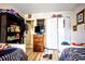 Well-organized bedroom showcasing two beds, spacious closets, and laminate floors at 11411 N 19Th St, Tampa, FL 33612