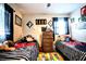 Shared bedroom featuring two beds, playful decor, and a colorful alphabet rug, perfect for siblings or guests at 11411 N 19Th St, Tampa, FL 33612