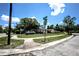 Street corner view showcasing a single-Gathering home with green space and parked vehicles along the road at 11411 N 19Th St, Tampa, FL 33612