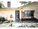 Exterior view of the home's front entrance with a decorative security door, trimmed window, and a small basketball hoop at 11411 N 19Th St, Tampa, FL 33612