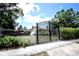 A secure iron gate offering privacy and security, leading to the home's front yard and entrance at 11411 N 19Th St, Tampa, FL 33612