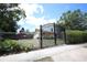 A secure iron gate offering privacy and security, leading to the home's front yard and entrance at 11411 N 19Th St, Tampa, FL 33612