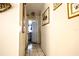 Hallway featuring neutral tones, tile floors, wall art, and several doors and openings at 11411 N 19Th St, Tampa, FL 33612