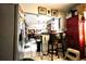 Kitchen featuring an eat-in bar that opens to the living room, appliances, and tiled floors for easy maintenance at 11411 N 19Th St, Tampa, FL 33612