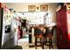 Open-concept kitchen with stainless steel appliances, wood cabinets, breakfast bar, and tiled flooring, perfect for entertaining at 11411 N 19Th St, Tampa, FL 33612